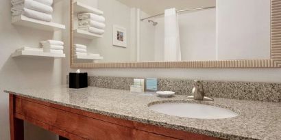 Guest bathroom with shower at Hampton Inn Phoenix-Midtown-Downtown Area.