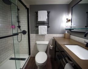 Guest bathroom with shower at Moxy Phoenix Tempe/ASU Area.