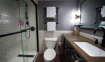 Guest bathroom with shower at Moxy Phoenix Tempe/ASU Area.