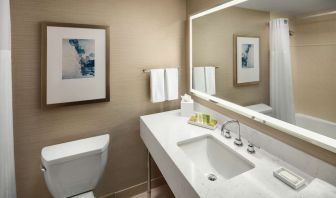 Guest bathroom with shower and tub at Hilton Boston Logan Airport.