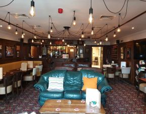 Hotel restaurant and bar with comfortable seating at Gatwick Belmont Hotel.