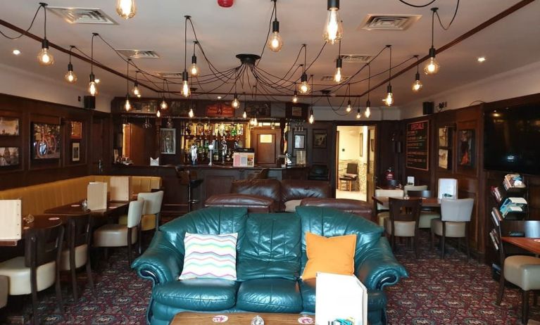 Hotel restaurant and bar with comfortable seating at Gatwick Belmont Hotel.