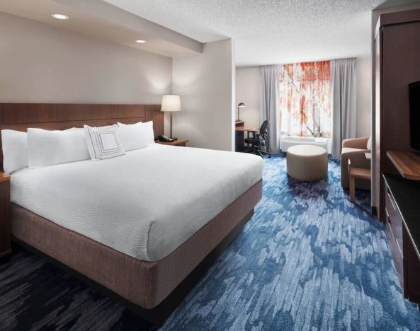 Day use room with work desk and sofa at Fairfield Inn By Marriott Denver Airport.