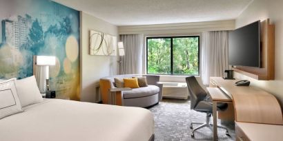 Day use room with sofa and work desk at Courtyard By Marriott Charlotte Airport/Billy Graham Parkway.