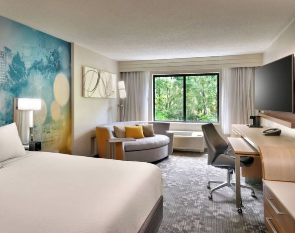 Day use room with sofa and work desk at Courtyard By Marriott Charlotte Airport/Billy Graham Parkway.