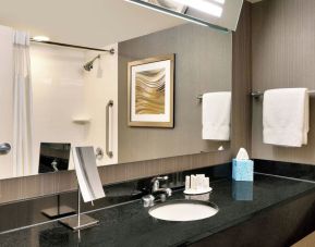 Guest bathroom with shower at Courtyard By Marriott Charlotte Airport/Billy Graham Parkway.