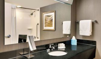 Guest bathroom with shower at Courtyard By Marriott Charlotte Airport/Billy Graham Parkway.