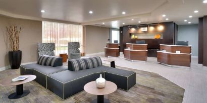 Lobby and coworking lounge at Courtyard By Marriott Charlotte Airport/Billy Graham Parkway.