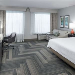 Spacious day use room with work desk and sofa at Hampton Inn & Suites Atlanta Perimeter Dunwoody.