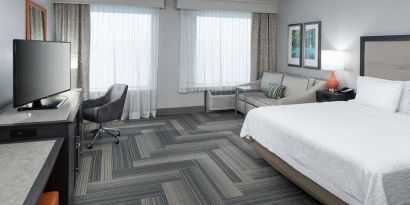 Spacious day use room with work desk and sofa at Hampton Inn & Suites Atlanta Perimeter Dunwoody.