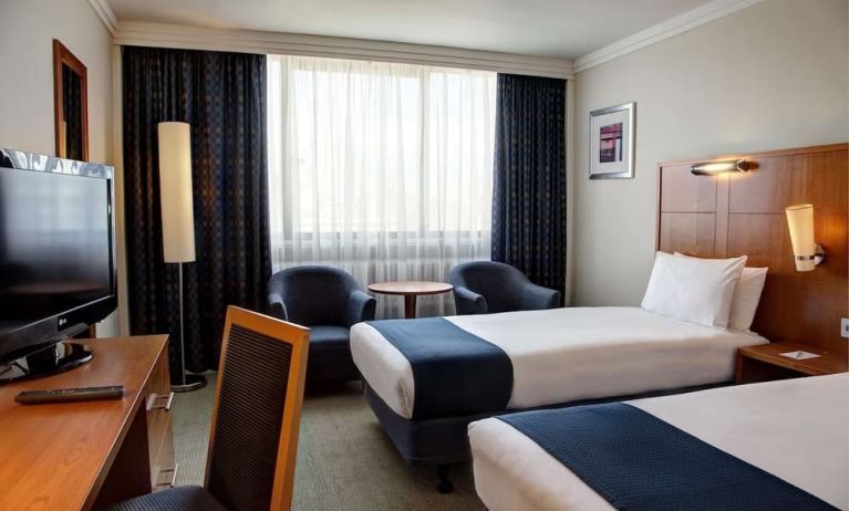 Day use twin room with work desk and lounge seating at Best Western London Heathrow Ariel Hotel.