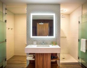 Guest bathroom with shower and free toiletries at Wyndham Garden North Bergen Near Secaucus.