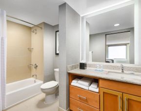 Guest bathroom with shower and tub at Hyatt HOUSE Fort Lauderdale Airport-South & Cruise Port.