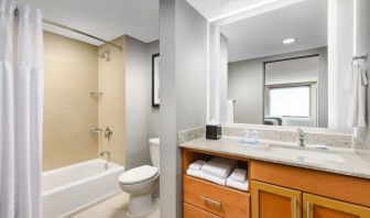 Guest bathroom with shower and tub at Hyatt HOUSE Fort Lauderdale Airport-South & Cruise Port.