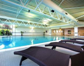 Indoor pool with lounge chairs at Crowne Plaza London - Heathrow.