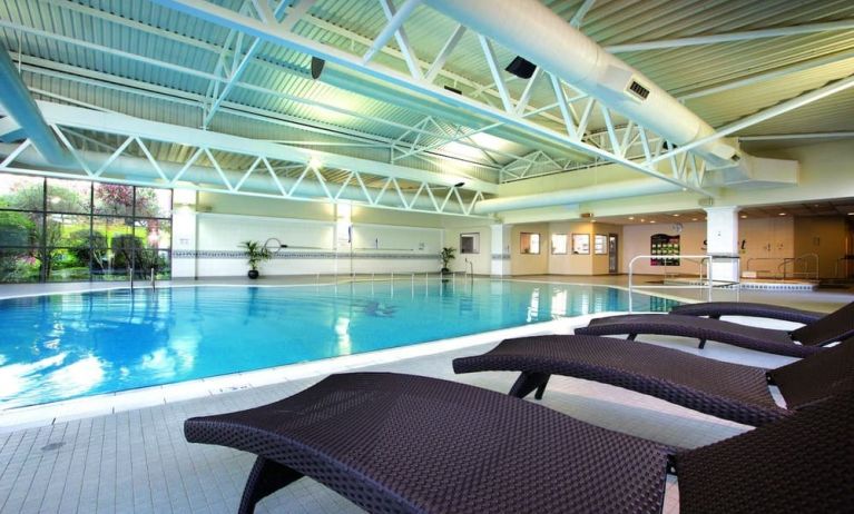 Indoor pool with lounge chairs at Crowne Plaza London - Heathrow.