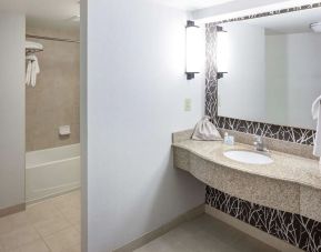 Guest bathroom with shower and tub at Hilton Garden Inn Nashville Vanderbilt.