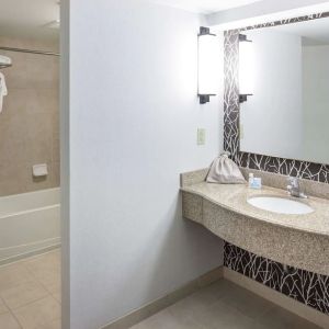 Guest bathroom with shower and tub at Hilton Garden Inn Nashville Vanderbilt.