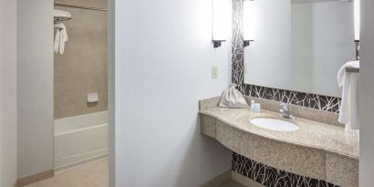 Guest bathroom with shower and tub at Hilton Garden Inn Nashville Vanderbilt.