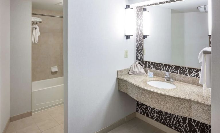 Guest bathroom with shower and tub at Hilton Garden Inn Nashville Vanderbilt.