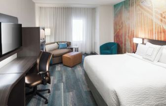 Day use room with work desk and sofa at Courtyard By Marriott Fort Worth Historic Stockyards.