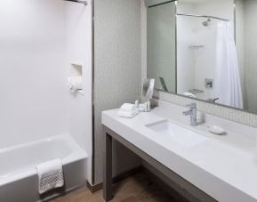 Guest bathroom with shower and tub at Courtyard By Marriott Fort Worth Historic Stockyards.