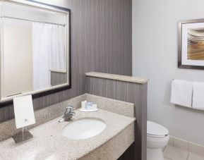 Guest bathroom with shower at Courtyard By Marriott Hattiesburg.