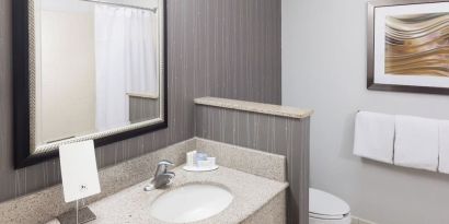 Guest bathroom with shower at Courtyard By Marriott Hattiesburg.