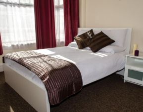 King bed at Campbell Guest House Hotel.