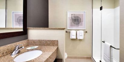 Guest bathroom with shower at Courtyard By Marriott Houston NASA/Clear Lake.