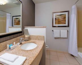 Guest bathroom with shower and tub at Courtyard By Marriott Montgomery Prattville.