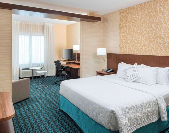 Day use room with work desk and sofa at Fairfield Inn & Suites By Marriott Houston Pasadena.