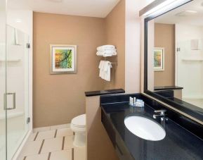 Guest bathroom with shower at Fairfield Inn & Suites By Marriott Houston Pasadena.