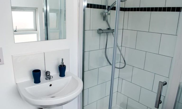 Private guest bathroom with shower and free toiletries at Trivelles Liverpool Hotel.