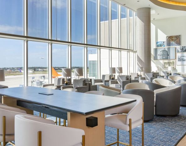 Ample seats with natural light perfect for coworking at Plaza Premium Lounge. Terminal C (MCO).