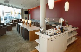 Ample seats beside self-serve bar at Plaza Premium Lounge - Terminal 3 (YYZ).