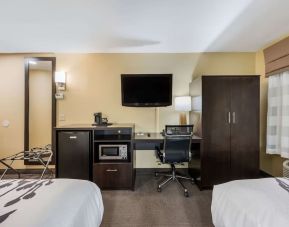 Work station with desk, TV, and mini-fridge at Spark By Hilton Oxford.