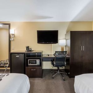 Work station with desk, TV, and mini-fridge at Spark By Hilton Oxford.