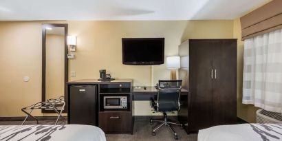 Work station with desk, TV, and mini-fridge at Spark By Hilton Oxford.