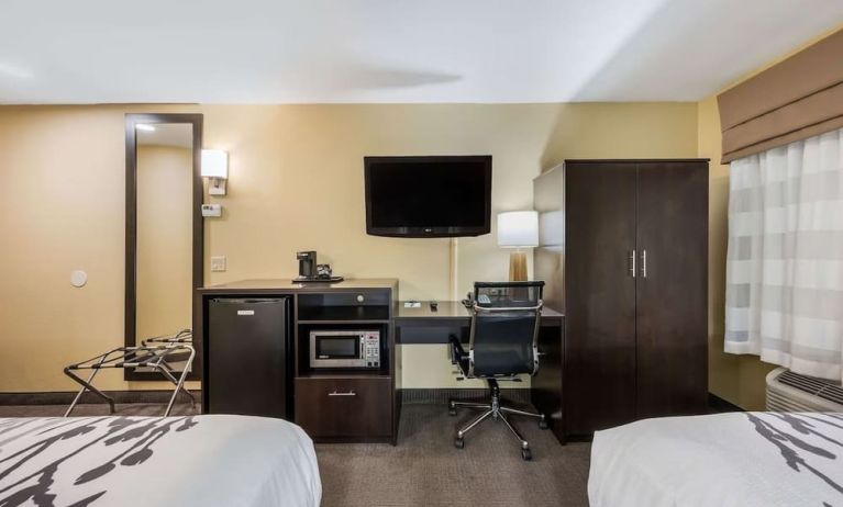 Work station with desk, TV, and mini-fridge at Spark By Hilton Oxford.