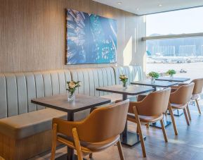 Ample seats with natural light perfect for coworking at Plaza Premium Lounge, Near Gate 35 - Terminal 1 (HKG).