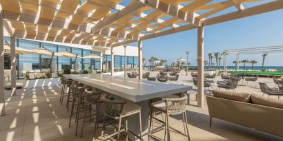 Outdoor seating at Hilton Skanes Monastir Beach Resort.