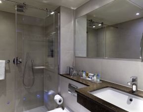 Private guest bathroom with shower and free toiletries at Blakemore Hyde Park Hotel.