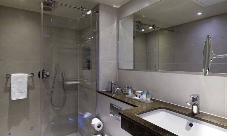 Private guest bathroom with shower and free toiletries at Blakemore Hyde Park Hotel.