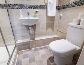 Private guest bathroom with shower and free toiletries at Tony's House Hotel.