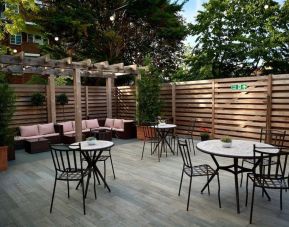 Terrace with seating area, perfect for coworking at The Lodge - Putney Hotel.