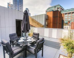 Roof terrace with seating at Room Home Stay.