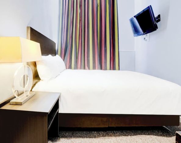 Day use room with TV screen and private bathroom at London Shelton Hotel.