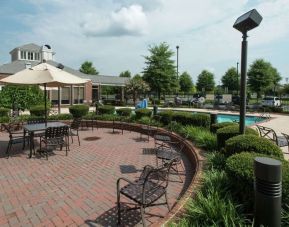 Seats available beside the pool at Hilton Garden Inn Macon / Mercer University.
