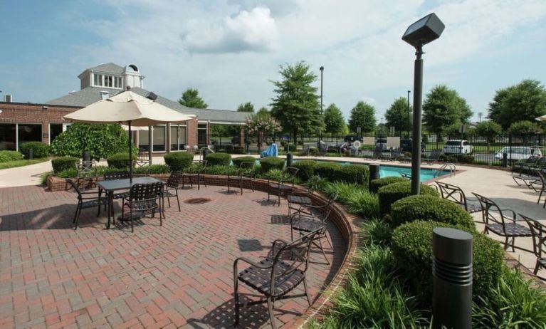 Seats available beside the pool at Hilton Garden Inn Macon / Mercer University.
